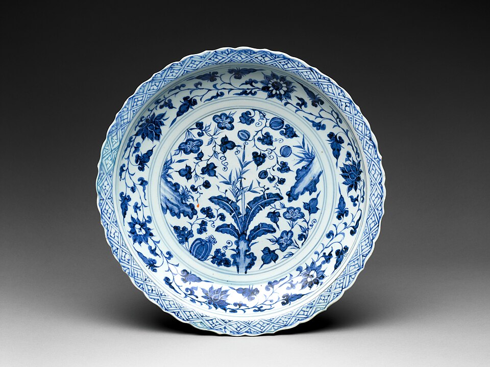 Chinese Blue-and-White Porcelain — Blue-and-white foliate-rim dish with rocks, flowering plants and melons, Yuan dynasty, 14th century — Wikimedia Commons / CC0